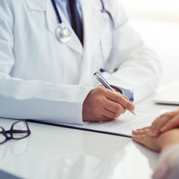 Male doctor and female patient talking at consultation.