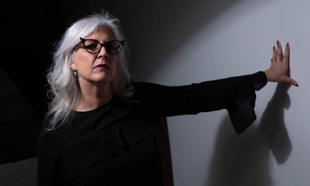 older woman with black cateye glasses