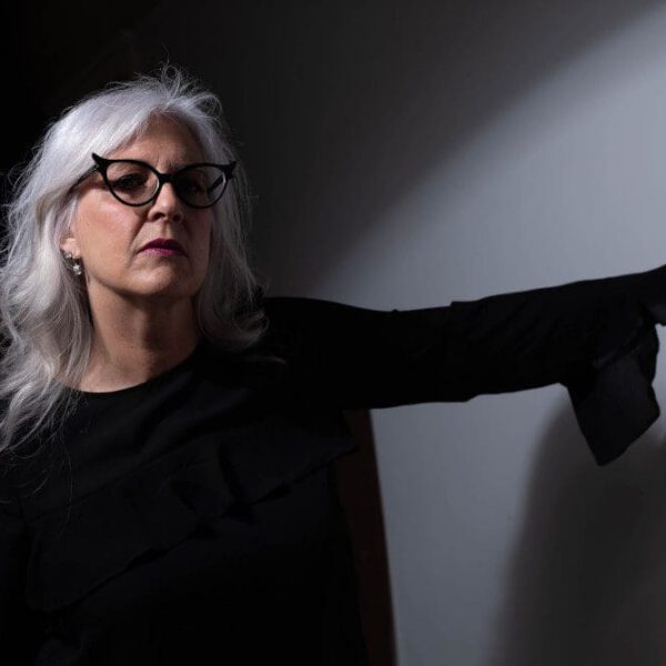 older woman with black cateye glasses