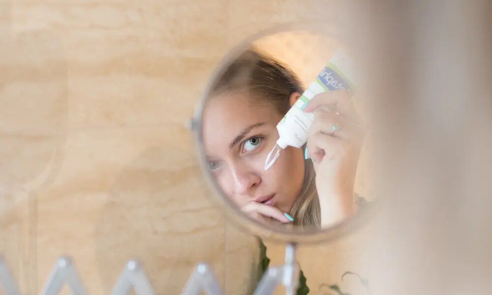 woman applying face cream