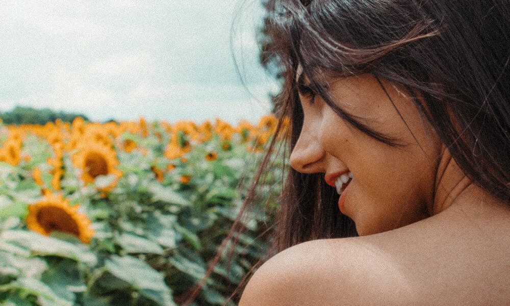 woman by field of flowers