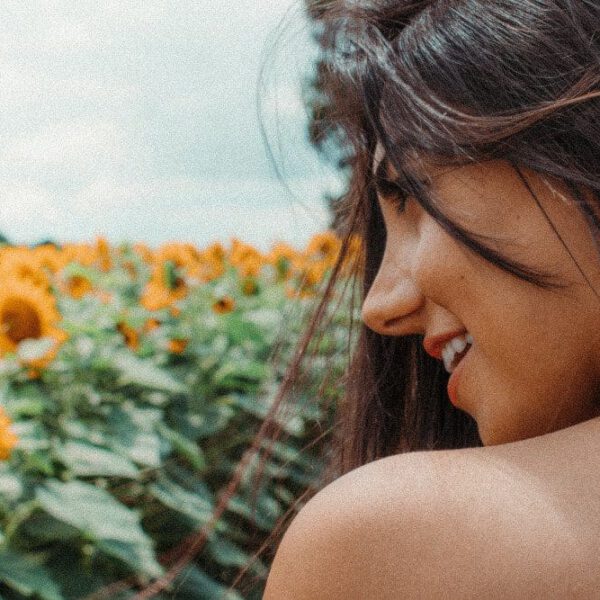 woman by field of flowers