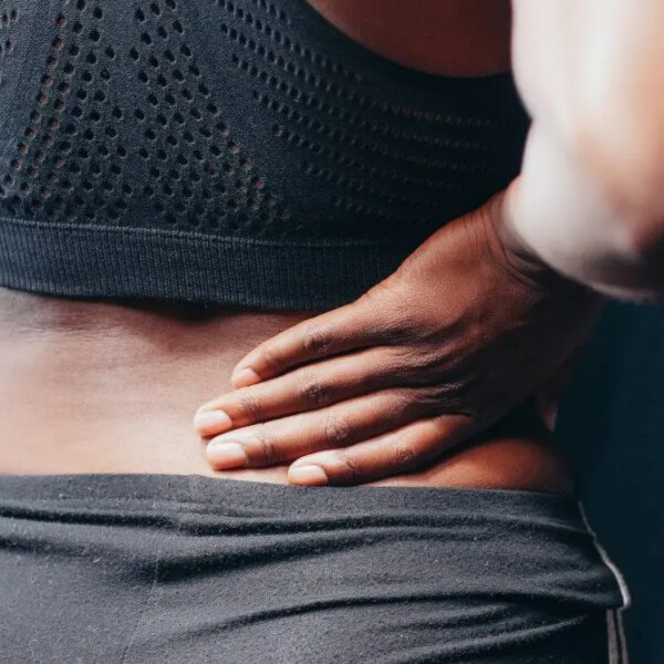woman holding her back