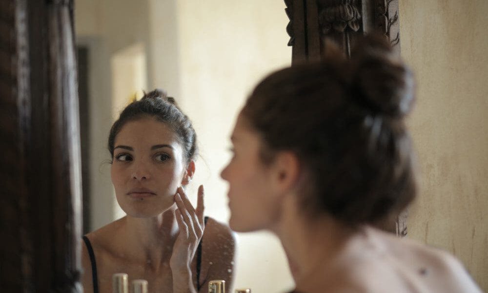 woman looking at mirror