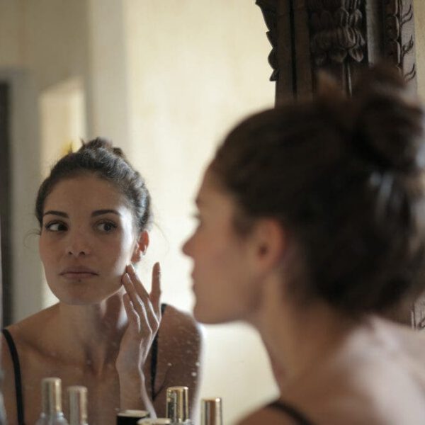 woman looking at mirror